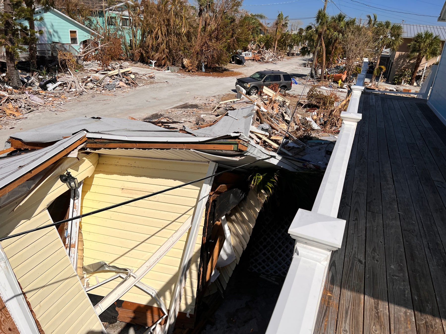 Collapsed structure and debris outside David Bauer’s home after the storm