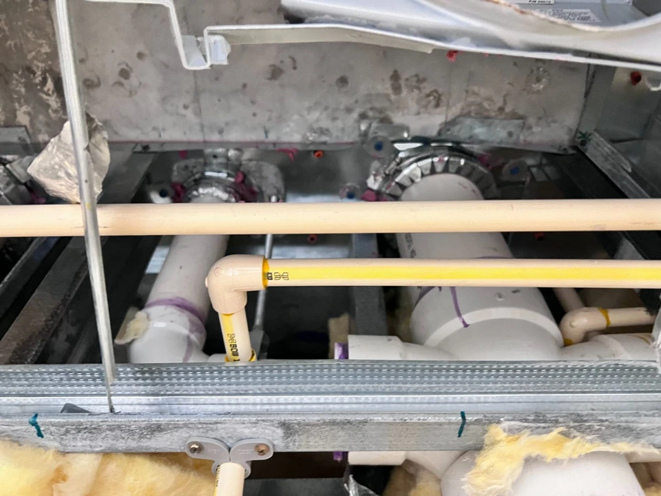 Exposed overhead plumbing lines and shutoffs before cover
